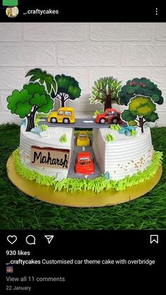 a cake with cars and trees on it in the shape of a car park, surrounded by green grass