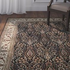 a chair and rug in front of a window