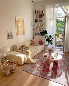 a living room filled with furniture and lots of windows