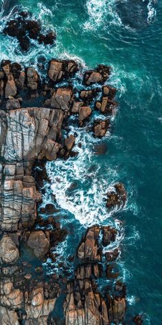 an aerial view of rocks and the ocean