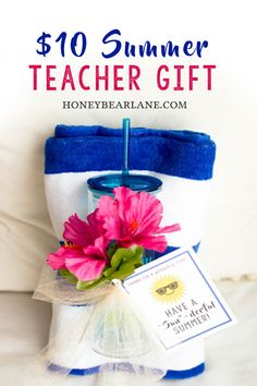 a blue and white bucket with pink flowers in it, next to a book titled $ 10 summer teacher gift