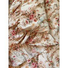 an image of a flowered bed sheet with ruffles and flowers on it