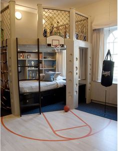 there is a basketball court in the middle of this room with bunk beds on it