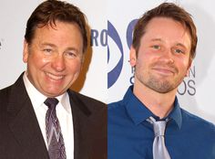 two men in suits and ties smiling for the camera, one is wearing a blue shirt