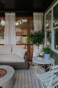 a living room filled with furniture and a fire pit