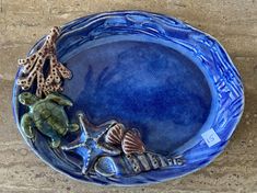 a blue plate with shells and sea animals on it