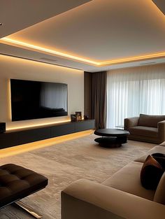 a living room with couches and a flat screen tv mounted on the wall above it