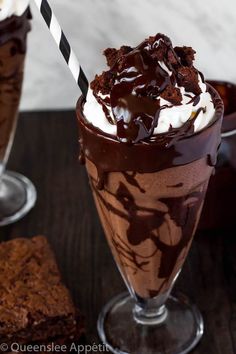 there is a chocolate milkshake with whipped cream and chocolate shavings on top