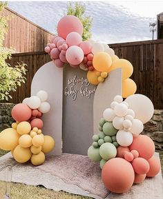 an arch decorated with balloons and streamers