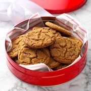 some cookies in a red tin on a table