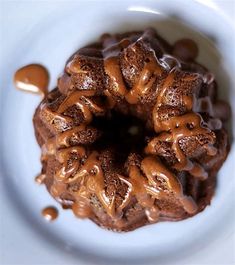 a bundt cake with chocolate frosting and caramel drizzle on top