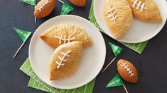 two football shaped pastries on white plates