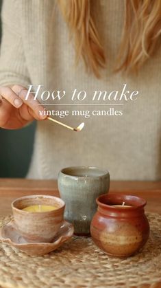 a woman is holding a spoon over some cups and saucers on a table with the words how to make vintage mug candles