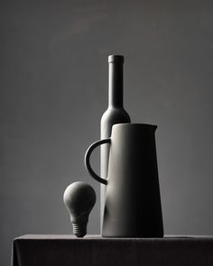 two vases and a light bulb on a table