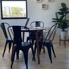 a dining room table with four chairs around it