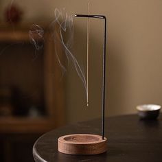 Description: Introducing the Walnut incense holder, crafted from high-quality walnut wood with elegant brass accents for a sophisticated look. This versatile holder doubles as a stylish interior decor piece for any room or office. Designed as the ultimate ash collector, the brass holder securely grips the incense stick, allowing ash to fall vertically into the holder, keeping your space clean and tidy. The unique inverted design enables you to place the incense upside-down, ensuring all ash is n Wooden Incense Holder Diy, Incense Aesthetic, Greenhouse Bar, Wood Incense Holder, Diy Incense Holder, Reading Rooms, Yoga Relaxation, Tea Houses, Indian Incense