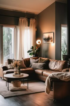 a living room filled with furniture and large windows