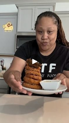 a woman sitting at a table with a plate of food