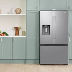 a stainless steel refrigerator with ice and water dispenser in a kitchen setting