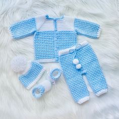 a blue and white crocheted baby outfit with matching booties