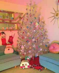 a white christmas tree sitting in the middle of a living room