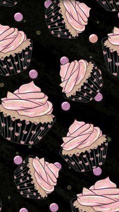 cupcakes with pink frosting and sprinkles on a black background