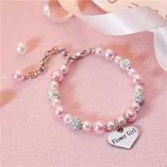 *Flower Girl Bracelet - This Bracelet Will Make A Beautiful Flower Girl Gift. Nothing Makes Little Girls Feel Special Than These Gifts. The Elegantly Engraved Flower Girl Heart Charm Will Make Her Feel Extraordinary. *Flower Girl Proposal - This Bracelet Comes With A "Flower Girl" Heart Charm, Pink Pearl, Cubic Zirconia Crystal, Cute And Sparkly, Your Flower Girl Must Be Happy To Get This Wonderful Gifts. *Flower Girl Gift From Bride - The Length Of The Chain Is About 6.5 Inch (16.5cm), The Diameter Is 2 Inch (5cm), The Extension Chain Is 2 Inch (5cm), Can Be Adjusted, Suitable For Most Wrists, Don't Worry About The Size. *Glass Pearl Flower Girl Bracelet - This Will Be Wonde Flower Girl Proposal, Flower Girl Bracelets, Girl Bracelet, Engraved Flower, A Beautiful Flower, Flower Girl Gifts, Girl Bracelets, Pearl Flower, Pink Bracelet