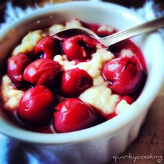 a bowl filled with ice cream and cherries