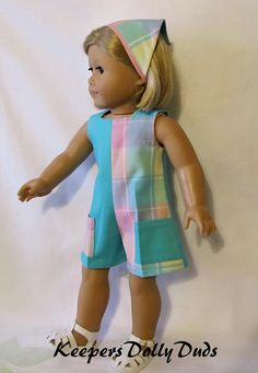 an american girl doll wearing a dress and hat