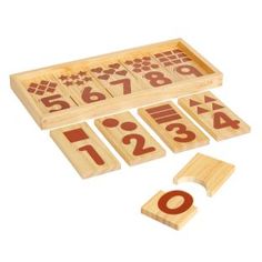 a wooden game set with numbers and symbols