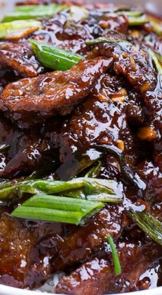 a close up of a plate of food with meat and asparagus on it