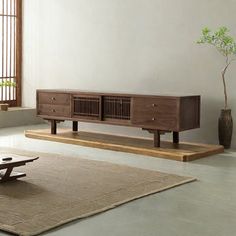 a living room scene with focus on the coffee table and sideboard in the background