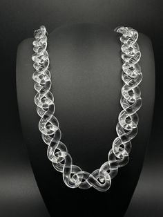 Add some pizzazz to your wardrobe with this stylish Transparent Clear Infinity Link Chain Necklace. With its unique design, it's the perfect accessory to complete any fashionable outfit. Made from high-quality acrylic, it is both durable and lightweight, making it comfortable to wear throughout the day. The necklace measures 22 inches in length and features an infinity link chain type that adds a touch of elegance and sophistication. The clear color is perfect for any occasion and can be worn by both men and women. Add this hip hop-themed necklace to your collection today and bring a new level of style to your wardrobe. Luxury Clear Necklaces For Formal Occasions, Luxury Clear Necklaces, Elegant Clear Chain Necklace, Adjustable Clear Necklace, Elegant Heart-shaped Clear Necklace, Chain Link Necklace, Chains Necklace, Chain Necklace, Unique Designs