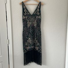 Nwt Babeyond Green V-Neck Dress Size: M Color: Deep Iridescent Green And Black Back Of Neck To End Of Fringe: 30 In (See Pic) Pit To Pit: 18 In Sleeveless, Sequined With A V-Neck Front And Deep V Back. Never Been Worn. Gorgeous Flapper Style Dress With Fringe. Beading Is Very Detailed With A Mix Of Sequins, Beads And Thread Also Included: Feather Headpiece Great For Halloween, Cosplay, Roaring 20’s Party Etc Embellished Fitted V-neck Flapper Dress, V-neck Party Dress With Beaded Fringe, V-neck Party Dresses With Rhinestone Fringe, V-neck Flapper Dress For Party Season, V-neck Embellished Sequin Dress For Festive Occasions, V-neck Dresses For Holiday Costume Party, Festive Embellished Midi Dress For Night Out, Festive Beaded Fringe Party Dress, Glamorous V-neck Dress With Rhinestone Fringe