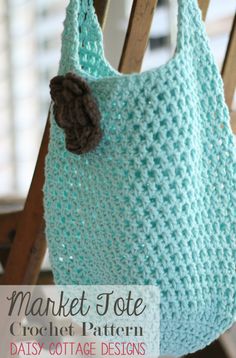 a crocheted bag hanging from a wooden chair