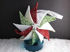 an origami christmas star decoration in a blue vase