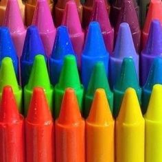 colorful crayons are lined up in rows and stacked on top of each other