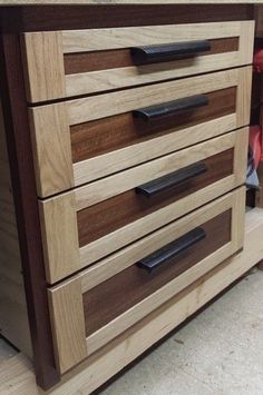 a close up of a wooden dresser with drawers