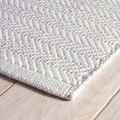 a white rug on top of a wooden floor