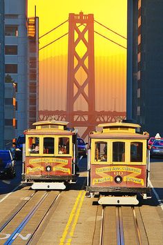 two trolley cars going down the tracks in san francisco