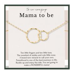 a gold necklace with two interlocked circles on it and the words mama to be written