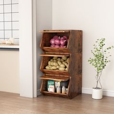 an open wooden box filled with vegetables on top of a hard wood floor next to a white wall