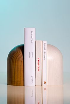 two books are sitting next to each other on a table with a light blue background