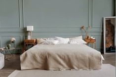 a bedroom with green walls and white bedding