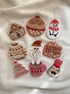 crocheted christmas ornaments are arranged on a white sheet