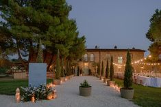 an outdoor wedding venue with candles lit up