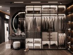 a walk - in closet with lots of clothes hanging on the walls and lights above it