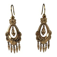 Victorian gold filled articulated long earrings in the Renaissance Revival taste. Gold filled metal has incised foliate motifs with two center hanging urns with small pendant drop fringes and french wire hooks. Excellent Condition. 1880's. L 1.3/4" x W 3/4" Antique Historical Drop Earrings, Antique Jewelry With Historical Design Drop Earrings, Antique Jewelry Drop Earrings With Historical Design, Antique Gold Chandelier Earrings In Brass, Antique Drop Earrings With Historical Design, Victorian Gold Chandelier Earrings In Brass, Victorian Style Ceremonial Dangle Earrings, Antique Formal Dangle Chandelier Earrings, Antique Dangle Chandelier Earrings For Formal Occasions