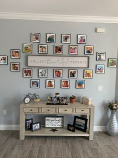 a wall with many pictures on it and a table in front of it that says collect beautiful moments