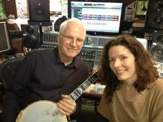 a man and woman sitting next to each other in front of a recording equipment set